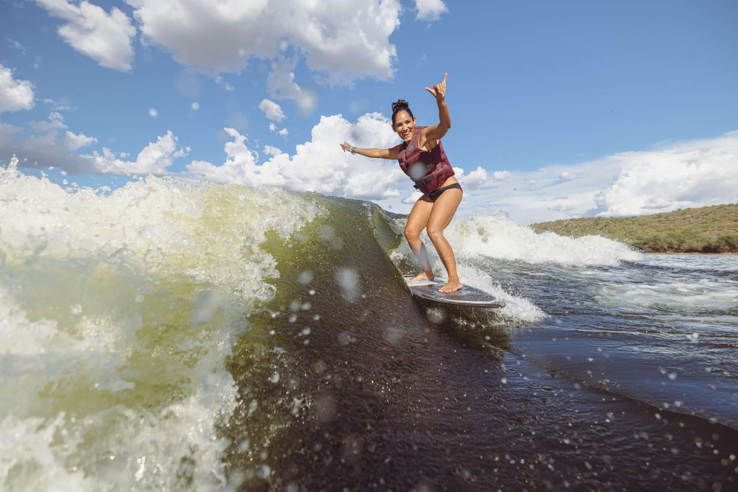 Woman surfing on surfstar wave