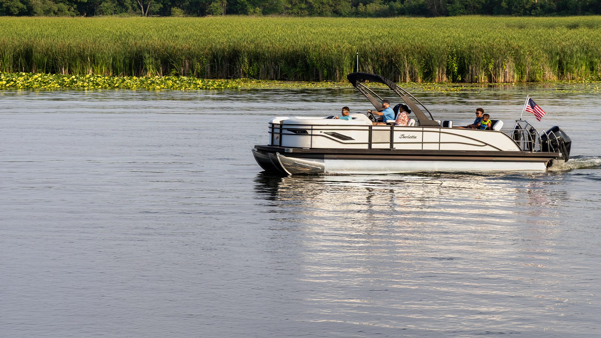 Family cruising on a Barletta pontoon in early fall
