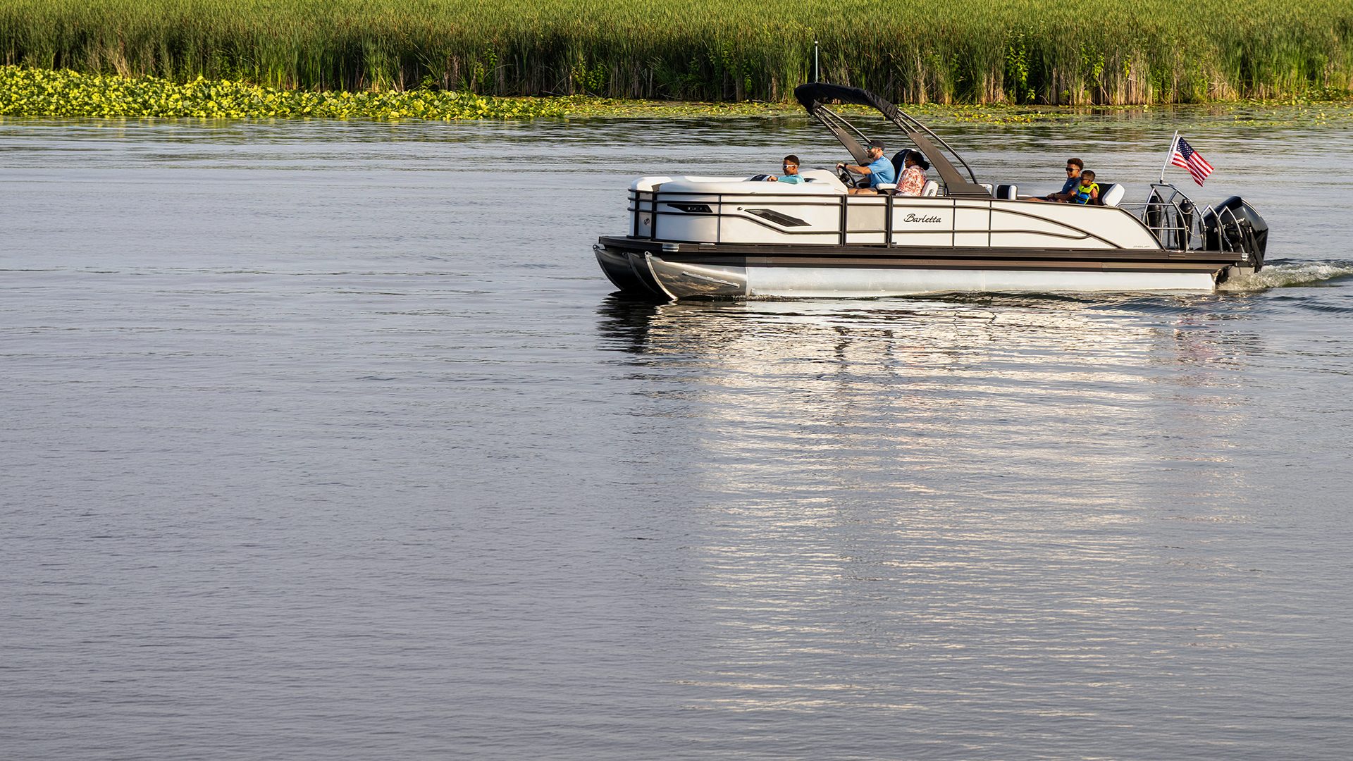 Family cruising on a Barletta pontoon in early fall