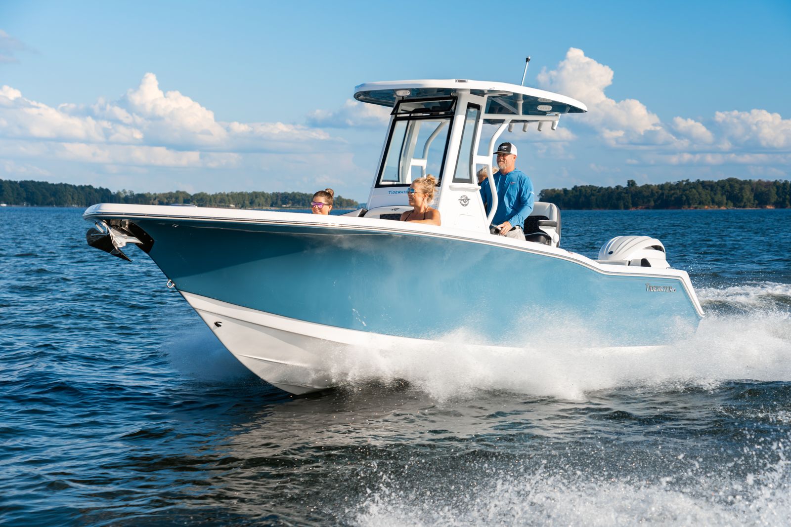 Family aboard a Tidewater center console at speed